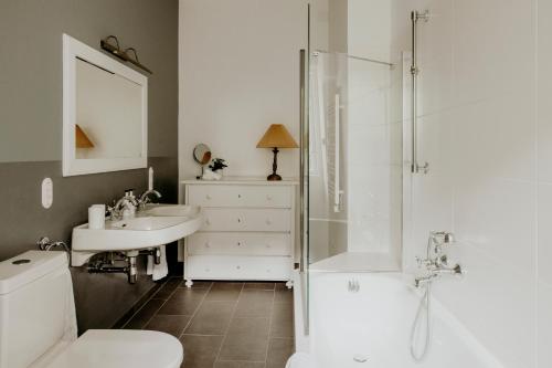 a bathroom with a toilet and a sink and a shower at Villa Weiss in Attersee am Attersee