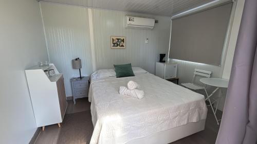 a bedroom with a bed with a towel on it at Cautiva Sleep Inn in Guácimo