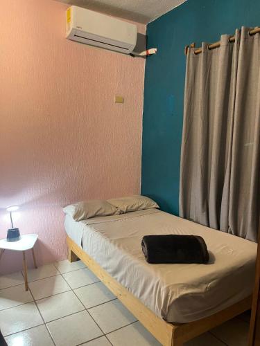 a bed in a room with aperature at Villa Gael Vacation Home in La Paz