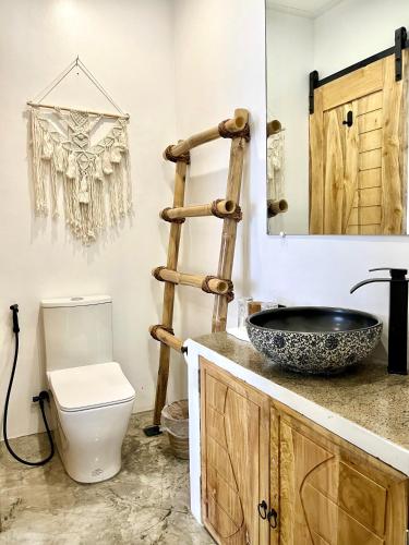 a bathroom with a toilet and a sink at Antuwanga reef resort in Moalboal