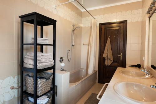 a bathroom with a tub and a sink and a shower at Casa-Friuli Doppelhaus Villa in Gradisca dʼIsonzo