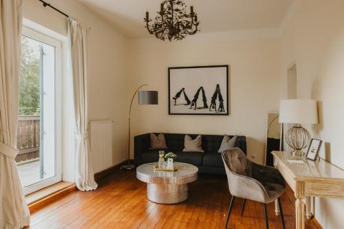 a living room with a couch and a table at Villa Weiss in Attersee am Attersee