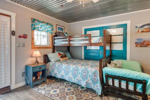 a bedroom with a bed and bunk beds in it at 1 Mi to Ocean Isle Beach! Studio w/ Outdoor Oasis in Ocean Isle Beach