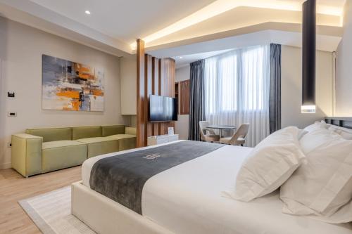 a hotel room with a bed and a couch at Numa Apart-Hotel in Tirana