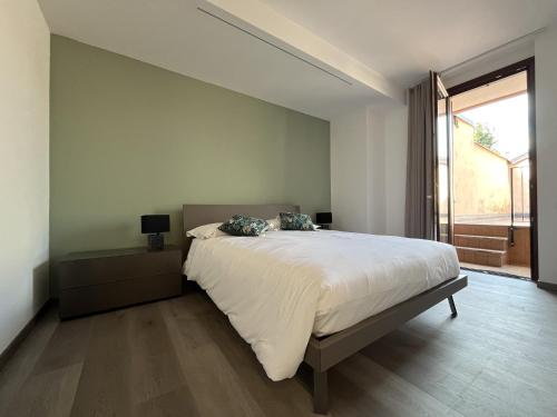 a bedroom with a large bed and a large window at Lake and Rocca Suite in Angera