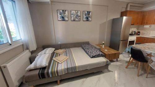 a small bedroom with a bed and a table at Family House Kat in Ioannina