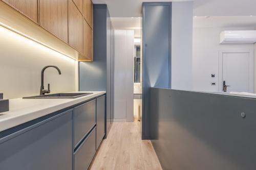 a kitchen with a sink and a counter top at Numa Apart-Hotel in Tirana