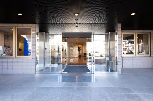 an empty lobby of a building with revolving doors at Yono Daiichi Hotel in Saitama