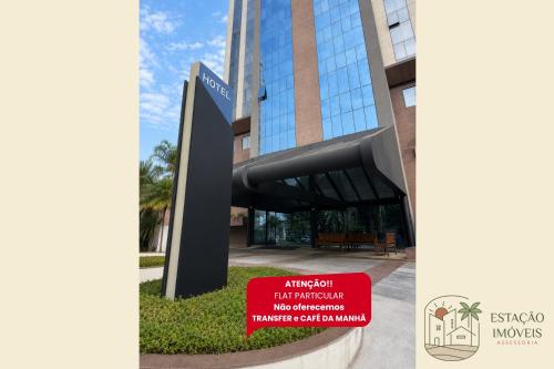 a building with a sign in front of it at Flat Hotel em Guarulhos in Guarulhos