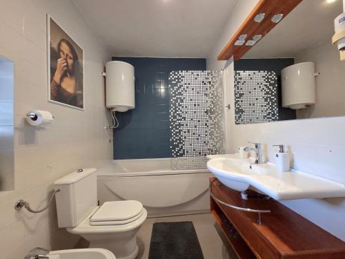 a bathroom with a toilet and a sink and a bath tub at Vila Ivana Jadranovo in Jadranovo