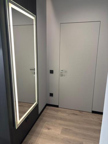 a bathroom with two doors and a mirror at Bavaro apartments 5 in Ivano-Frankivsk