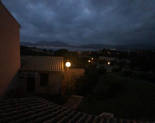 a street light on top of a house at night at Casamea - T2, Piscine, Vue Mer, Clim, Balcon in Porticcio