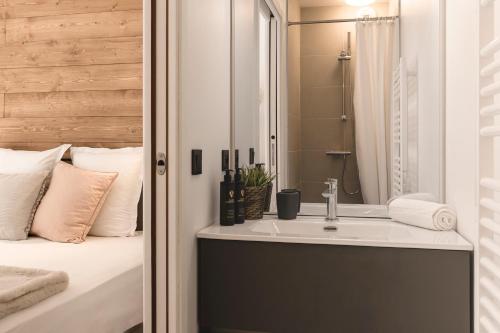 a bathroom with a sink next to a bed at Apartment Leo - 2BR, Modern, Lift access, Mountain views in Les Houches