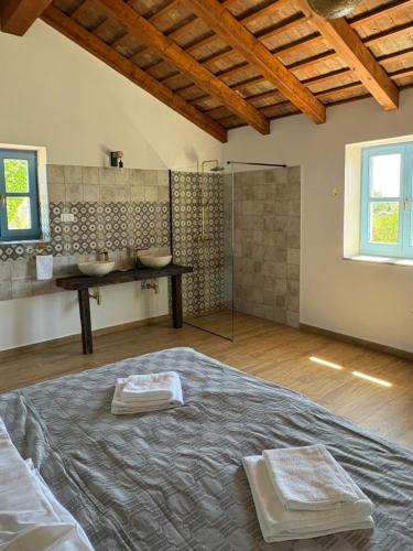 a master bathroom with a bed and a shower at Villa Francesca with Private Pool & Designer Interior in Kaštel