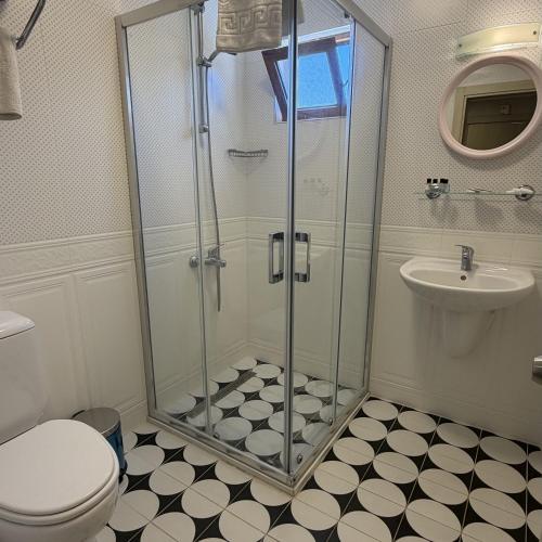 a bathroom with a shower and a toilet and a sink at Arya Otel in Marmaris