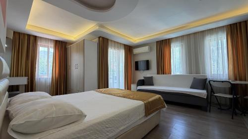 a hotel room with a bed and a couch at Arya Otel in Marmaris