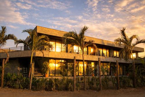 a building with palm trees in front of it at Palomino Sunrise in Palomino