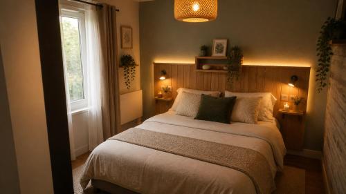 a bedroom with a large bed and a window at La détente in Féchain