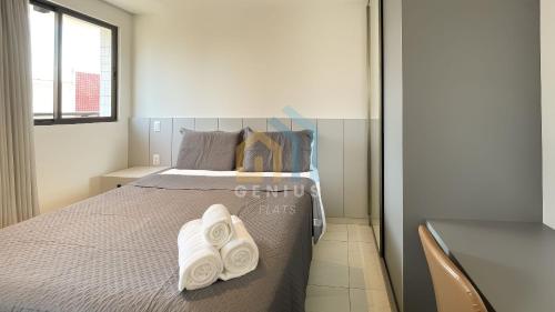 a bedroom with a bed with two towels on it at Compact Tambaú Genius Flats in João Pessoa
