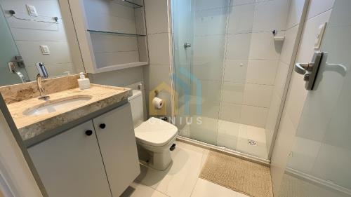 a bathroom with a toilet and a glass shower at Compact Tambaú Genius Flats in João Pessoa