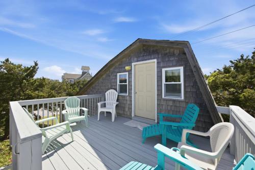 a tiny house with chairs on a deck at 7604 - Uncle Pooh's Cottage in Avon
