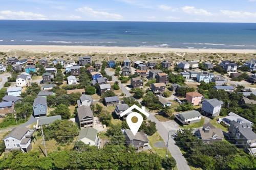 an aerial view of a neighborhood with houses and the ocean at 7604 - Uncle Pooh's Cottage in Avon