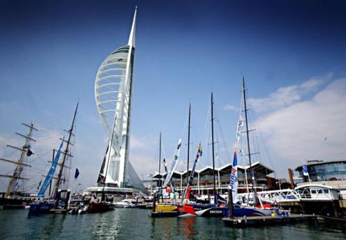 a group of boats docked in a harbor with a ferris wheel at Gunwharf Quays Harbour Apartments in Portsmouth
