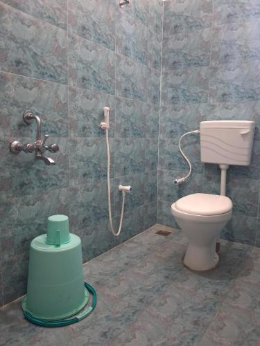a bathroom with a toilet and a shower at Srivaari Residency Villa in Pondicherry