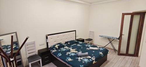 a bedroom with a bed and a mirror in it at H apartment in Yerevan