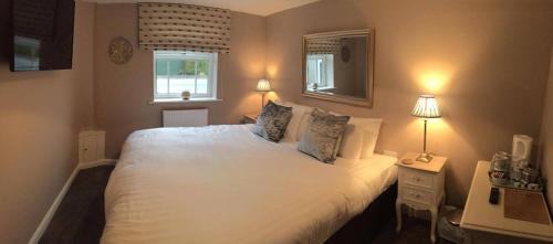 sypialnia z dużym białym łóżkiem z 2 lampami w obiekcie The Anchor Inn w mieście Sutton Bridge