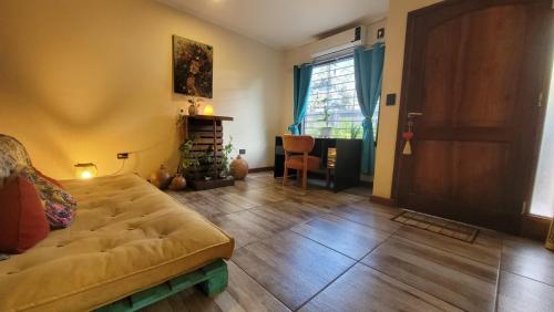 a living room with a couch and a fireplace at Ombú Guests House in Puerto Iguazú