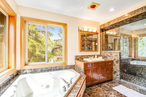 a bathroom with a tub and a sink and a shower at Teanaway River Lodge in Cle Elum