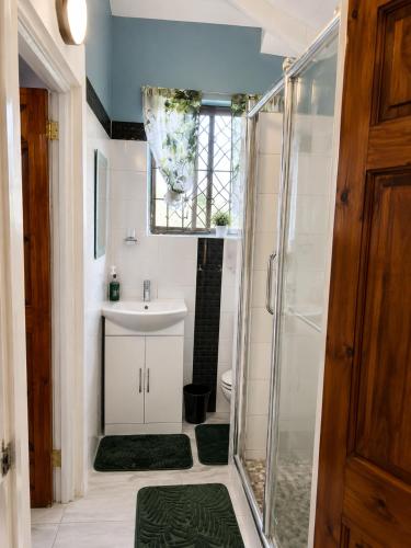a bathroom with a sink and a shower at Paradise Inn in Laborie