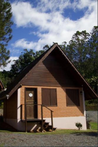 a small house with a porch and a door at Pousada Casarão Gastehaus in Pomerode