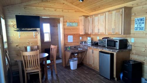 a kitchen with a counter and a microwave in a cabin at Lake Minden Camping Resort Cottage 1 in Nicolaus