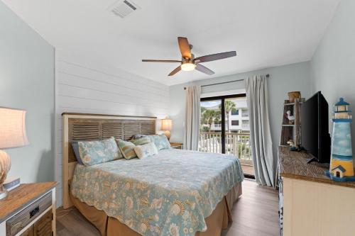 a bedroom with a bed and a flat screen tv at VitaminSeaGrove in Santa Rosa Beach