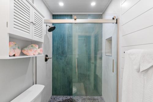 a bathroom with a shower with a glass door at VitaminSeaGrove in Santa Rosa Beach