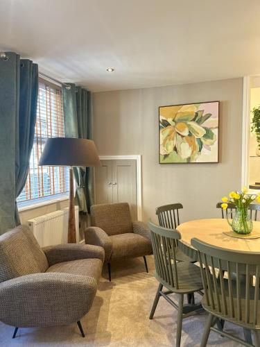 a living room with a table and chairs at No 3 Chapel Row in Bakewell