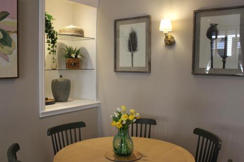 a table with a vase of flowers on it at No 3 Chapel Row in Bakewell