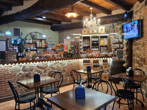 a restaurant with tables and chairs in a room at Hostal El Rincón del Trillo in La Alberca