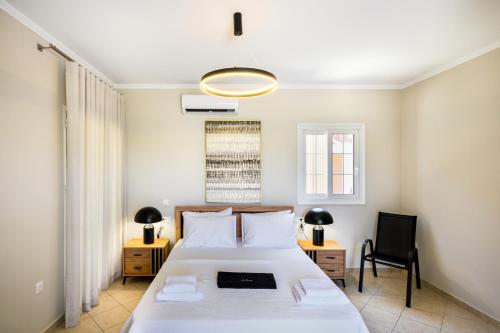 a bedroom with a bed and a desk and a chair at ML Houses Lefkada in Tsoukalades