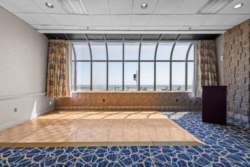 a large room with a large window with a view of the ocean at The Barclay Towers Hotel and Resort in Virginia Beach