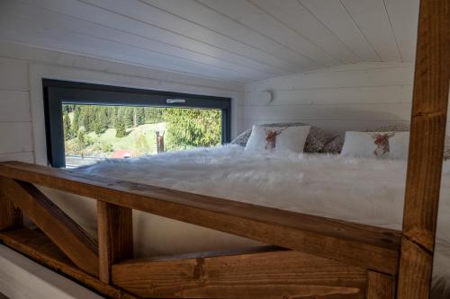 a large bed in a room with a window at Na samote u Noemi in Komjatná