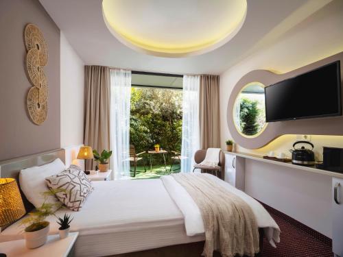 a hotel room with a bed and a large window at İS Hotel in Antalya