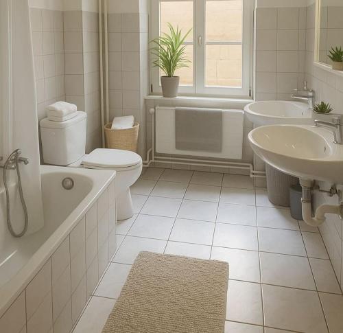 a white bathroom with a tub and a toilet and a sink at Basel Shared Apartment in Basel