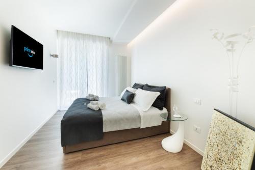 a bedroom with a bed with a teddy bear on it at The Iconic Ceccarini - Riviera Collection in Riccione