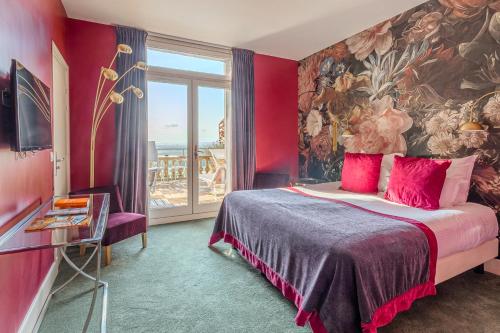 a bedroom with a bed and a large window at Domaine De La Corniche in Rolleboise