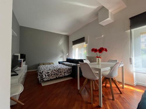 a living room with a table and a bed at Maison de l'Eau by Lago Maggiore Rentals in Verbania