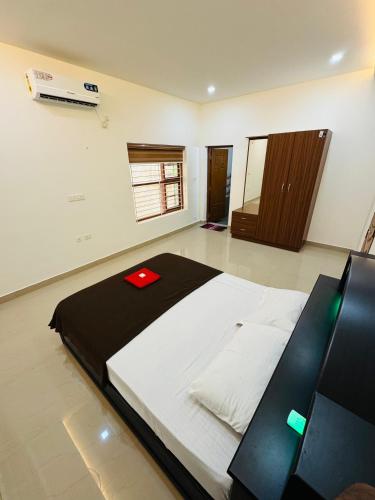 a bedroom with a large bed in a room at Iconic villas by ROYAL VILLAS in Athirappilly