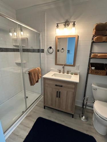 a bathroom with a sink and a shower and a toilet at Chucks Cottage in Cape Charles in Cape Charles